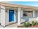 Close-up of the home's blue front door with white trim, flanked by lanterns, offering a welcoming entrance at 2169 Webster Ct, Deltona, FL 32738