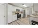 Spacious kitchen featuring white cabinetry, stainless appliances, and granite countertops at 2169 Webster Ct, Deltona, FL 32738