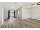 Open living space featuring wood flooring, neutral walls, and sliding glass doors to the outdoor living area at 2169 Webster Ct, Deltona, FL 32738