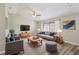 Cozy living room with vaulted ceiling, hardwood floors, neutral paint, ceiling fan and stylish contemporary furniture at 2169 Webster Ct, Deltona, FL 32738