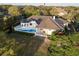 Stunning aerial view of a large home with a private pool and well-manicured lawn at 2207 Cairns Ct, Orlando, FL 32835