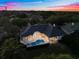 Aerial view of a beautiful home with a pool, spa, and manicured backyard at 2207 Cairns Ct, Orlando, FL 32835