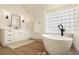 Soaking tub in bathroom featuring a glass block window and modern fixtures at 2207 Cairns Ct, Orlando, FL 32835