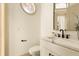 Modern powder room features a decorative mirror and marble countertop sink at 2207 Cairns Ct, Orlando, FL 32835