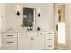 Well-lit bathroom features a double vanity with decorative light fixtures at 2207 Cairns Ct, Orlando, FL 32835