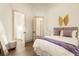 Bright bedroom with a queen bed, wood-look floors, and a stylish butterfly wall decor at 2207 Cairns Ct, Orlando, FL 32835