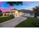 Stunning home exterior featuring a paved driveway, lush landscaping, and elegant architectural design at 2207 Cairns Ct, Orlando, FL 32835