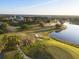 Aerial view of a scenic golf course with winding paths and a serene lake at 2207 Cairns Ct, Orlando, FL 32835