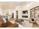 Spacious living area with modern fireplace, built-ins, and adjacent kitchen with island seating at 2207 Cairns Ct, Orlando, FL 32835