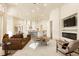 Open-concept living area with sleek furniture, modern lighting, and views into the kitchen at 2207 Cairns Ct, Orlando, FL 32835