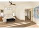 Bright main bedroom with white walls, modern fan, and light wood floors at 2207 Cairns Ct, Orlando, FL 32835