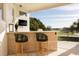 Covered outdoor bar with seating and a TV is the perfect place to entertain guests at 2207 Cairns Ct, Orlando, FL 32835