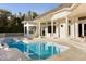 Backyard pool and spa with lush landscaping offer a private oasis for relaxation and recreation at 2207 Cairns Ct, Orlando, FL 32835