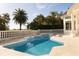 Beautiful backyard pool with spa and manicured lawn with mature trees at 2207 Cairns Ct, Orlando, FL 32835