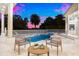 Beautiful backyard pool and patio at dusk beneath a colorful sky and palm trees at 2207 Cairns Ct, Orlando, FL 32835