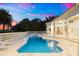 Beautiful backyard pool and patio at dusk beneath colorful sky and palm trees at 2207 Cairns Ct, Orlando, FL 32835