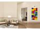 Cozy sitting area featuring hardwood floors, two chairs, and colorful wall art at 2207 Cairns Ct, Orlando, FL 32835