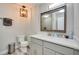 Modern bathroom with a quartz countertop vanity, framed mirror and decorative pendant lighting at 224 E Kelly Park Rd, Apopka, FL 32712