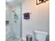 Sleek bathroom featuring tile shower with glass door and updated fixtures with a modern toilet at 224 E Kelly Park Rd, Apopka, FL 32712