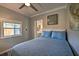 Comfortable bedroom with a ceiling fan, window, and a view of the adjacent kitchen area at 224 E Kelly Park Rd, Apopka, FL 32712