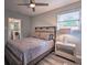 Bedroom featuring a decorative lamp and an adjacent bathroom at 224 E Kelly Park Rd, Apopka, FL 32712