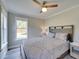 Comfortable bedroom with large windows, ceiling fan, and a decorative wooden headboard at 224 E Kelly Park Rd, Apopka, FL 32712