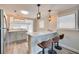 Bright kitchen featuring a quartz breakfast bar with stylish pendant lighting and seating for three at 224 E Kelly Park Rd, Apopka, FL 32712