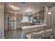 Large kitchen featuring gray cabinets, stainless steel appliances, countertop seating, and tile flooring at 224 E Kelly Park Rd, Apopka, FL 32712