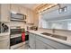 Modern kitchen with stainless steel appliances, quartz counters, and a stylish pendant light fixture at 224 E Kelly Park Rd, Apopka, FL 32712