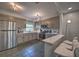 Spacious kitchen with stainless steel appliances, stylish gray cabinetry, and breakfast bar seating at 224 E Kelly Park Rd, Apopka, FL 32712