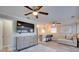 Living room with a ceiling fan, a TV, and a stylish dresser with view into the breakfast bar at 224 E Kelly Park Rd, Apopka, FL 32712