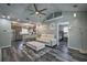Open floor plan: living room flowing into modern kitchen, with a comfortable seating area, and natural light at 224 E Kelly Park Rd, Apopka, FL 32712