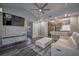Living room with a modern open floor plan connecting to the kitchen and dining area, and stylish gray floors at 224 E Kelly Park Rd, Apopka, FL 32712