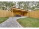 Outdoor dining pavilion with a table and chairs, nestled within a beautifully fenced backyard at 224 E Kelly Park Rd, Apopka, FL 32712