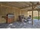 Covered outdoor patio featuring a built-in grill station and a cozy dining setup with table and chairs at 224 E Kelly Park Rd, Apopka, FL 32712
