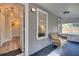 Inviting enclosed porch featuring a comfortable wicker chair and easy access to the interior at 224 E Kelly Park Rd, Apopka, FL 32712