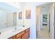 Bathroom featuring a modern vanity, decorative mirror, and a glimpse of the shower at 2555 Shanti Dr, Kissimmee, FL 34746