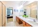 Bright bathroom with double vanity, quartz countertop, and decorative plants at 2555 Shanti Dr, Kissimmee, FL 34746