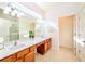 Spacious bathroom with dual sinks, quartz countertop, and lots of mirrors at 2555 Shanti Dr, Kissimmee, FL 34746