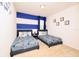 ' bedroom featuring two twin beds with colorful decor and whimsical wall art at 2555 Shanti Dr, Kissimmee, FL 34746