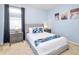Cozy bedroom featuring a queen bed, soft blue walls, and stylish nightstands at 2555 Shanti Dr, Kissimmee, FL 34746