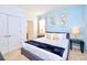 Comfortable bedroom featuring a queen bed, soft blue walls, and tasteful decor at 2555 Shanti Dr, Kissimmee, FL 34746