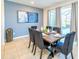 Elegant dining room with a wooden table, upholstered chairs, and large windows at 2555 Shanti Dr, Kissimmee, FL 34746