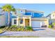 Beautiful two-story home featuring a modern design, well-maintained landscaping, and an attached two-car garage at 2555 Shanti Dr, Kissimmee, FL 34746