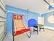 Fun game room with foosball, basketball game, and epoxy floors at 2555 Shanti Dr, Kissimmee, FL 34746