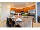 Kitchen island featuring granite countertops, seating, and modern stainless appliances at 2555 Shanti Dr, Kissimmee, FL 34746