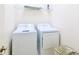 Functional laundry room equipped with a modern washer and dryer, and storage shelving at 2555 Shanti Dr, Kissimmee, FL 34746