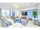 Bright living room with plush gray sofas, blue accents, and modern furnishings at 2555 Shanti Dr, Kissimmee, FL 34746