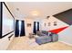 Home theater room features a large projector screen and comfortable gray sofa with decor pillows at 2555 Shanti Dr, Kissimmee, FL 34746