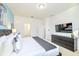 Neutral main bedroom featuring a large bed and black dresser beneath the wall-mounted TV at 2555 Shanti Dr, Kissimmee, FL 34746